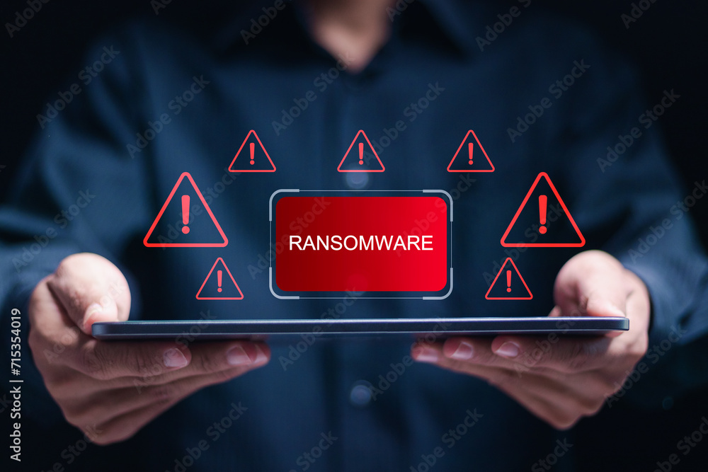 Poster malware attack virus alert. person use tablet with virtual warning sign with ransomware word. warnin