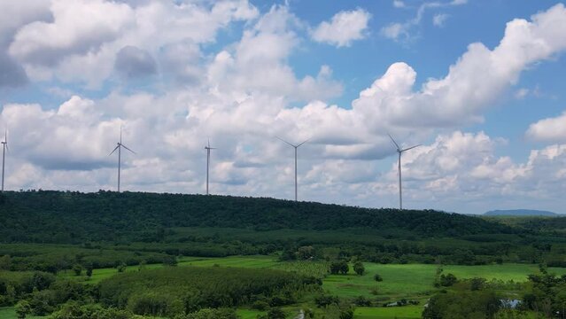Wind turbines produce electricity on top of the mountain.