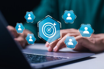 Targeting customer concept. Businessman use laptop with target customer icons for customer focus group. Digital marketing online, CRM, Data exchanges development and customer service.
