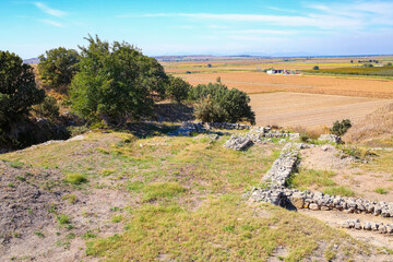Fototapeta na wymiar Archaeological site of ancient Troy. Remains of ruined buildings. Hisarlik hill. Tevfikiye (Cankkale), Turkey (Turkiye)