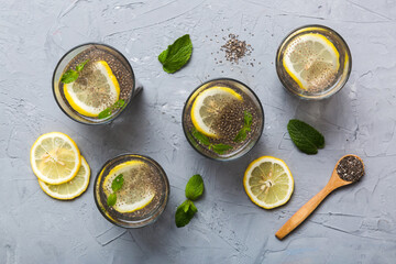 Healthy breakfast or morning with chia seeds lemon and mint on table background, vegetarian food,...