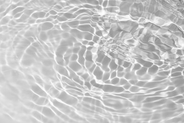 White water with ripples on the surface. Defocus blurred transparent white colored clear calm water surface texture with splashes and bubbles. Water waves with shining pattern texture background.