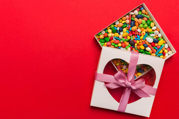 Box with sweet chocolate candies on color background, Various candy sweets. Valentines day gift box. Top view flat lay with copy space