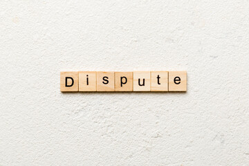 dispute word written on wood block. dispute text on table, concept