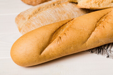 Homemade natural breads. Different kinds of fresh bread as background, perspective view with copy space