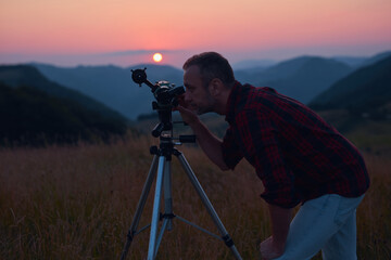Astronomer looking at the sun with a telescope.