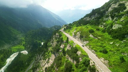 Aerial drone view of scenic Susten pass drive in Swiss Alps. Switzerland summer tourism destination. Alpine road trip road. 
