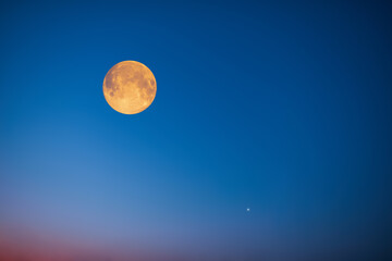 Full Moon and planet conjunction on a colorful sky.