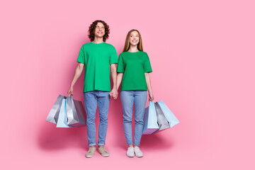 Full body length photo of youngsters enjoy shopping together in new supermarket looking banner copyspace isolated on pink color background