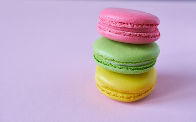 Colorful macaroons on a pink background. Copy space.