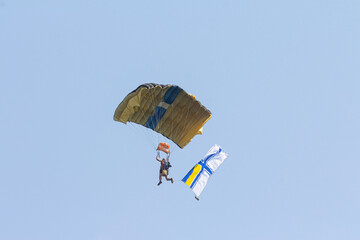 A parachutist with the flag of the Naval Forces of Ukraine in the sky above the city of Odesa