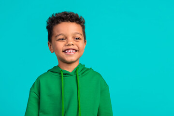 Photo of toothy beaming optimistic schoolboy dressed green pullover look at discount empty space...