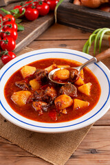 Beef goulash, soup and a stew, made of beef steak, potatoes and plenty of paprika. Hungarian traditional meal, typical Czech food