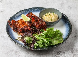 chao ta grilled pork ribs with plai rice, lemon and green leaves served in dish isolated on grey background top view of singapore food