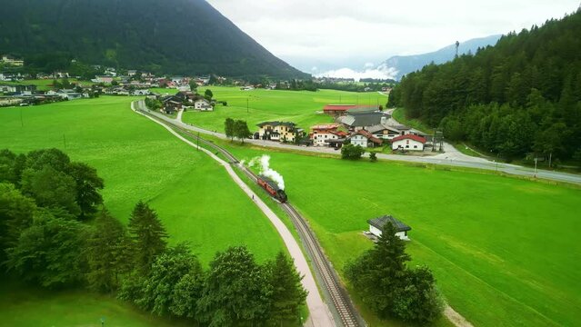 cog railway steam train on Achen Lake Achensee in Austrian Alps. popular tourist sightseeing destination in Tyrol region. Drone aerial view 