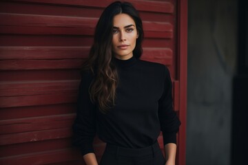 Portrait of a young beautiful brunette woman in a black sweater.