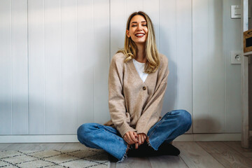 People leisure lifestyle concept. Young female wearing stylish clothing laughing having rest at home