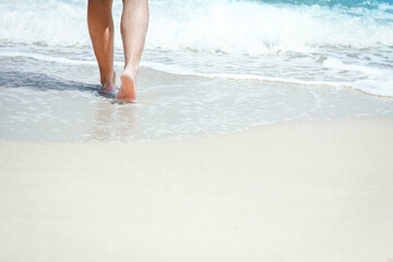 A Feet and footprints by the seashore in nature travel vacation background