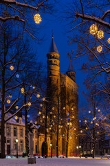 Maastricht, Netherlands 01-19-2024 Basilica of Our Lady and the square during twilight, covered with fresh snow during winter time and illuminated with Christmas decoration, creating a magical scene 