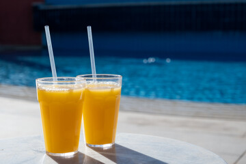 Refreshing cocktail near swimming pool, close up