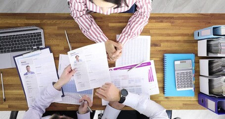 Business people holding resume for job placement woman top view 4k movie slow motion. Unemployment concept