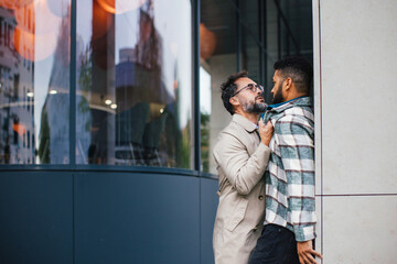 Violence against man on street. Angry man is aggressive, have conflict with young man, holding him by shirt, screaming, threatening him.