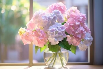 a vase filled with pink and purple flowers on top of a window sill next to a window sill.