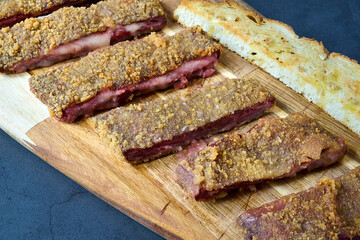 Fried pork chop with breadcrumbs and fried potatoes on wooden board