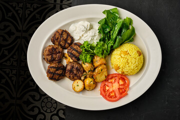 Meat kofta dish with rice and vegetables