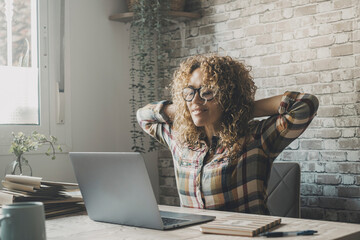 Fototapeta premium Satisfied happy woman finish to work on a laptop computer on the desk. Small business start up indoor leisure activity people. Online digital business job. Surfing net. Happy expression female smile