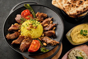Butter fried lamb dish with rice and appetizers