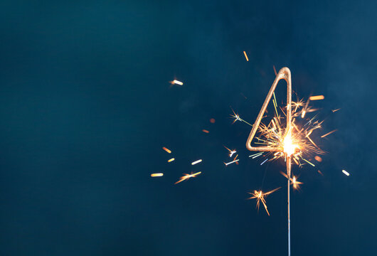 4 years celebration festive background made with Bengal fires in the form of number Four.