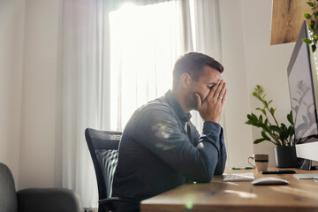 An entrepreneur having burnout at home office. - obrazy, fototapety, plakaty