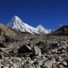 Fototapeta na wymiar Stony trail of the Everest Base Camp Trek and snow covered Mount Pumori, Nepal.