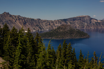 Mesmerizing Crater Lake, with its deep blue waters reflecting the snow-capped peaks of Mount Mazama, a captivating natural wonder nestled in the Cascade Mountains of Oregon.