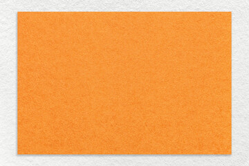 Texture of craft orange color paper background with white border, macro. Vintage kraft ginger cardboard