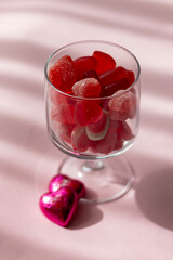 Valentine's day concept with red hearts and candies on wooden table