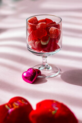 Valentine's day concept with red hearts and candies on wooden table