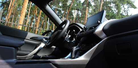 Panoramic photo of the interior of the car with a view of the green hedge of the park in the...