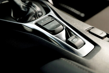 black interior of a modern car. Dashboard. Luxury leather steering wheel. Auto controls. Car doors...