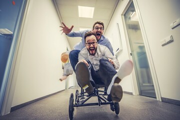 Lighthearted and comical image of two good humoured colleagues getting up to some mischief in the office. 