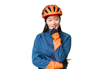 Young cyclist woman over isolated chroma key background looking to the side - obrazy, fototapety, plakaty