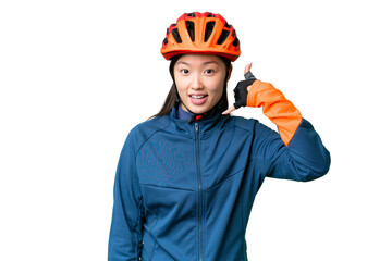 Young cyclist woman over isolated chroma key background making phone gesture. Call me back sign