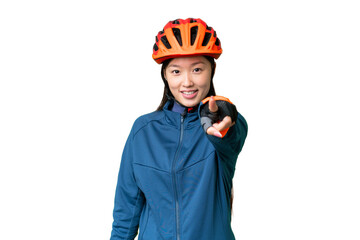 Young cyclist woman over isolated chroma key background points finger at you with a confident expression