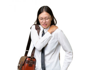 Young Asian business woman over isolated background suffering from pain in shoulder for having made an effort