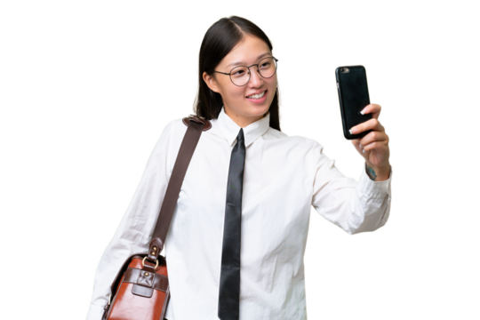 Young Asian business woman over isolated background making a selfie