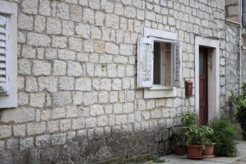 Beautiful old building with stone wall, window and door