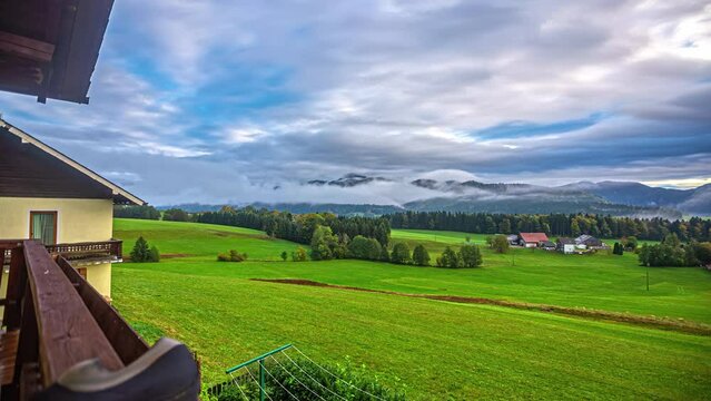 View from the balcony of a rural house in the middle of a green landscape.