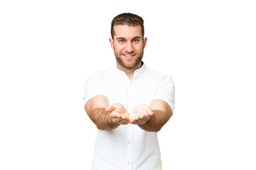 Young handsome blonde man over isolated chroma key background holding copyspace imaginary on the...