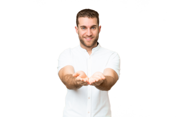 Young handsome blonde man over isolated chroma key background holding copyspace imaginary on the palm to insert an ad